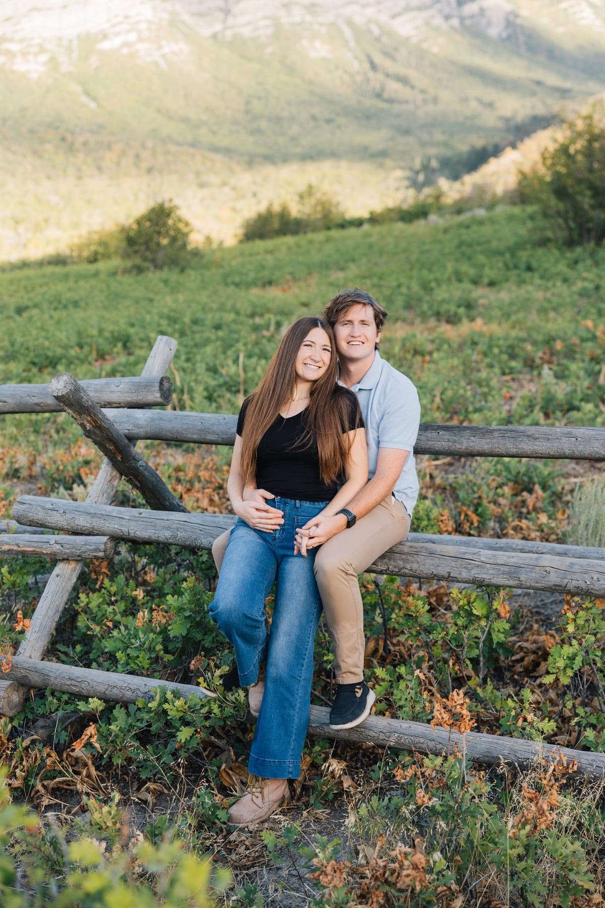Ewan Morkel, Enrolled Agent and founder of Morkel Financial, with his wife on a split-rail fence below the Wasatch foothills in Mapleton, Utah